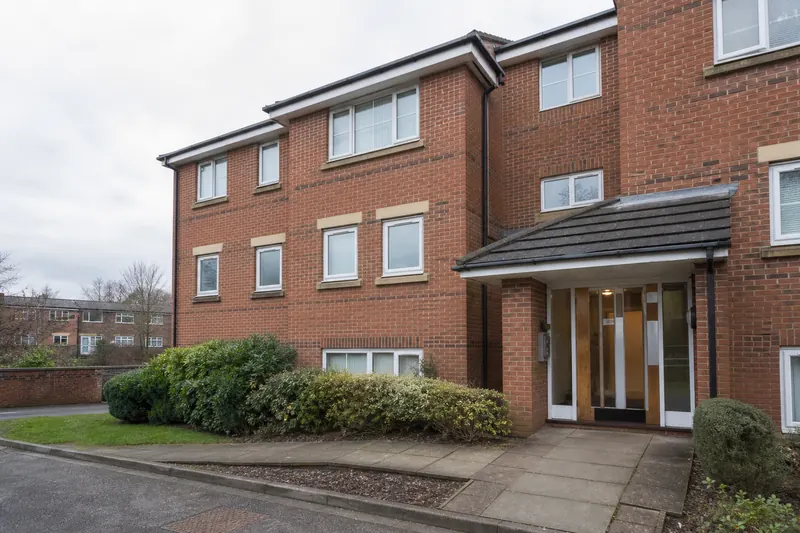 Low-rise red-brick apartment building in Greater Manchester